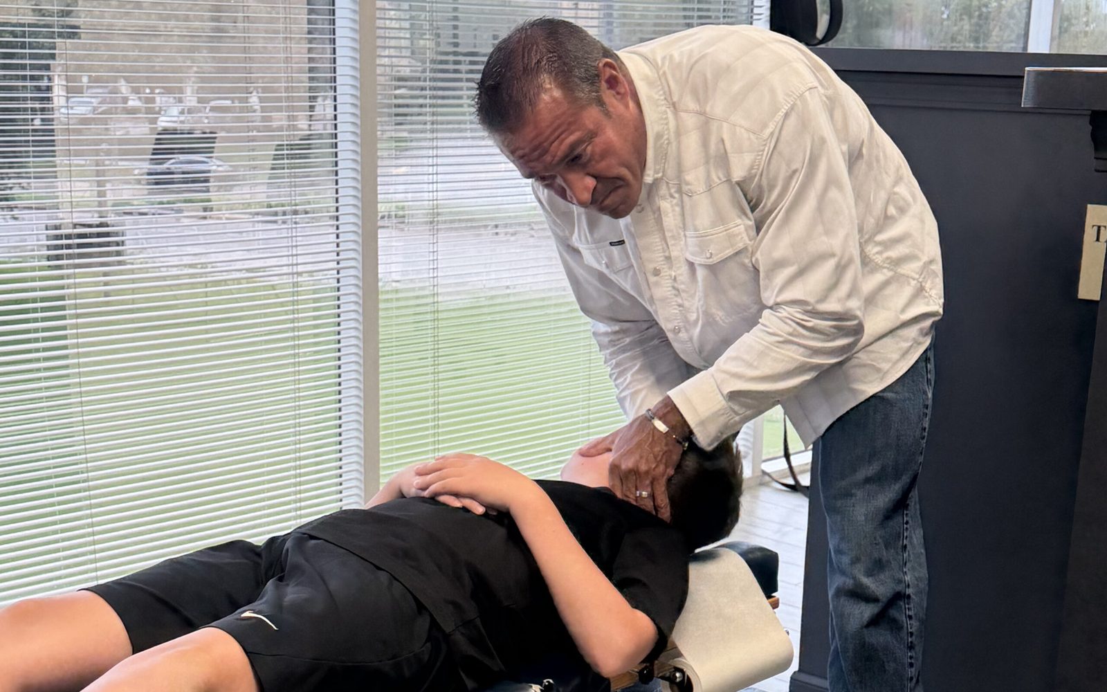Dr. Roberto Cantu providing a chiropractic adjustment